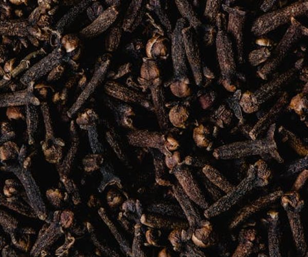 Close-up view of aromatic dried cloves, showcasing texture and rich brown color.
